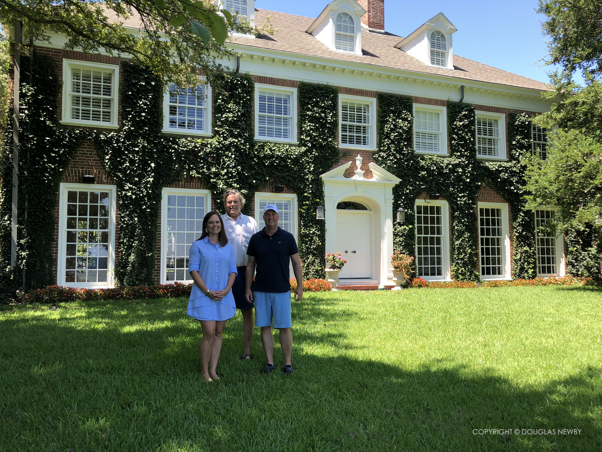 Douglas Newby celebrating with friends and clients at recently purchased estate home