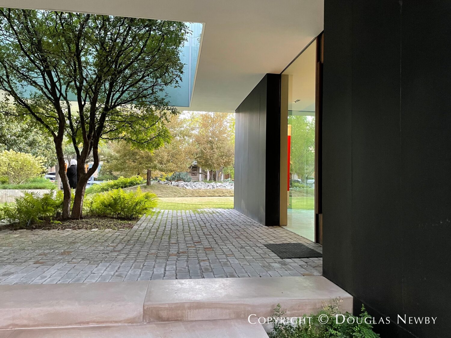 Architecturally significant home in Highland Park includes a cutout in cantilevered second floor to showcase tree.
