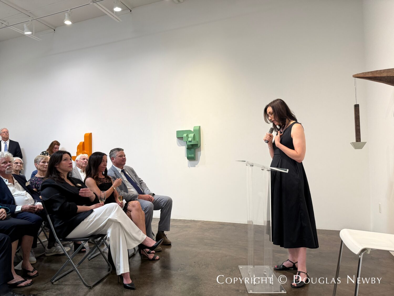 Gallerist Cris Worley speaks at the John Reoch Celebration of Life held at the Conduit Gallery in Turtle Creek area of Dallas.